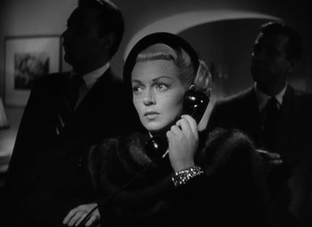Movie still from “The Bad and the Beautiful” (1952), directed by Vincente Minnelli – An old photo of a woman talking on a phone; Close Up shot, Low angle