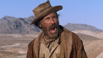 Movie still from “The Ballad of Cable Hogue” (1970), directed by Sam Peckinpah – A man with a hat and a beard is yelling; Close Up shot, Low angle