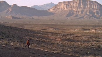 Movie still from “The Ballad of Cable Hogue” (1970), directed by Sam Peckinpah – A person in an orange shirt is walking in the desert; Extreme Wide shot, High angle