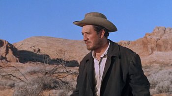 Movie still from “The Ballad of Cable Hogue” (1970), directed by Sam Peckinpah – A man wearing a cowboy hat standing in the desert; Medium shot, Low angle