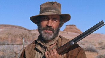 Movie still from “The Ballad of Cable Hogue” (1970), directed by Sam Peckinpah – A person holding a gun; Close Up shot, Low angle