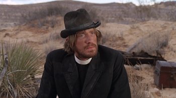 Movie still from “The Ballad of Cable Hogue” (1970), directed by Sam Peckinpah – A man wearing a hat and a black suit; Close Up shot, Low angle