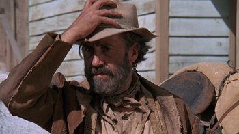 Movie still from “The Ballad of Cable Hogue” (1970), directed by Sam Peckinpah – A man with a beard and a hat on; Close Up shot, Low angle