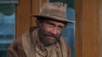 Movie still from “The Ballad of Cable Hogue” (1970), directed by Sam Peckinpah – A man with a beard wearing a hat and a jacket; Close Up shot, Low angle