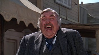 Movie still from “The Ballad of Cable Hogue” (1970), directed by Sam Peckinpah – An older man in a suit and tie laughing; Close Up shot, Low angle