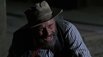 Movie still from “The Ballad of Cable Hogue” (1970), directed by Sam Peckinpah – An old man with a beard and a hat is smiling; Close Up shot, Low angle
