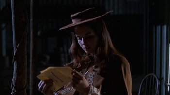 Movie still from “The Ballad of Cable Hogue” (1970), directed by Sam Peckinpah – A woman in a hat is looking at a piece of paper; Close Up shot, Over the shoulder angle