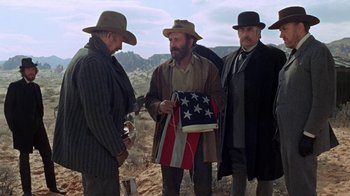 Movie still from “The Ballad of Cable Hogue” (1970), directed by Sam Peckinpah – A group of men standing next to each other on top of a hill; Medium shot, Low angle