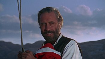 Movie still from “The Ballad of Cable Hogue” (1970), directed by Sam Peckinpah – A man with a beard holding a red and white jacket; Close Up shot, Low angle