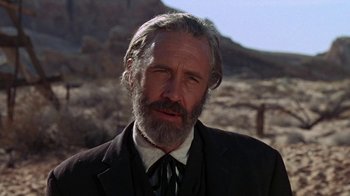 Movie still from “The Ballad of Cable Hogue” (1970), directed by Sam Peckinpah – An older man with a beard wearing a suit and tie; Close Up shot, Low angle