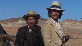 Movie still from “The Ballad of Cable Hogue” (1970), directed by Sam Peckinpah – A couple of men standing next to each other in hats; Medium shot, Low angle