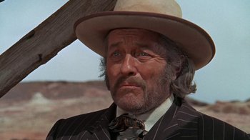 Movie still from “The Ballad of Cable Hogue” (1970), directed by Sam Peckinpah – An older man in a suit and a hat; Close Up shot, Low angle