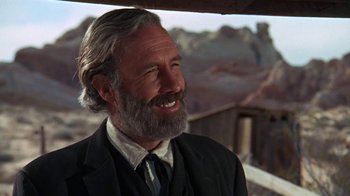Movie still from “The Ballad of Cable Hogue” (1970), directed by Sam Peckinpah – An older man with a beard and a suit and tie; Close Up shot, Low angle