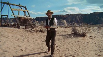 Movie still from “The Ballad of Cable Hogue” (1970), directed by Sam Peckinpah – An old man in a hat is standing in the desert; Wide shot, Low angle