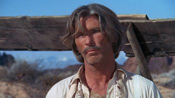 Movie still from “The Ballad of Cable Hogue” (1970), directed by Sam Peckinpah – A person with long grey hair; Close Up shot, Low angle