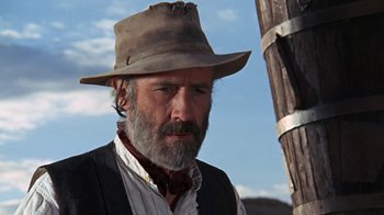Movie still from “The Ballad of Cable Hogue” (1970), directed by Sam Peckinpah – A man with a gray beard wearing a brown hat; Close Up shot, Low angle