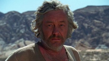 Movie still from “The Ballad of Cable Hogue” (1970), directed by Sam Peckinpah – A person with a mountain in the background; Close Up shot, Low angle