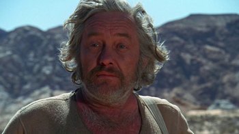 Movie still from “The Ballad of Cable Hogue” (1970), directed by Sam Peckinpah – An older man with long white hair and a beard; Close Up shot, Low angle