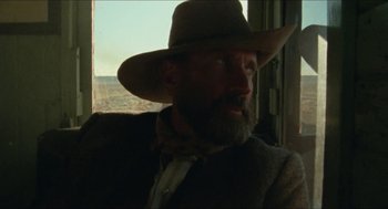 Movie still from “The Ballad of Gregorio Cortez” (1982), directed by Robert M. Young – A man with a beard wearing a cowboy hat; Close Up shot, Low angle
