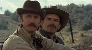 Movie still from “The Ballad of Gregorio Cortez” (1982), directed by Robert M. Young – A couple of men wearing hats standing next to each other; Close Up shot, Low angle
