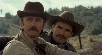 Movie still from “The Ballad of Gregorio Cortez” (1982), directed by Robert M. Young – A couple of men wearing hats standing next to each other; Close Up shot, Low angle