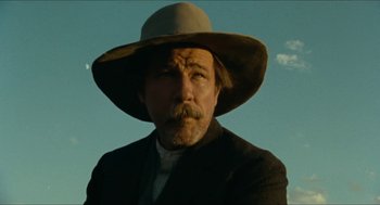 Movie still from “The Ballad of Gregorio Cortez” (1982), directed by Robert M. Young – A person wearing a hat and a suit; Close Up shot, Low angle