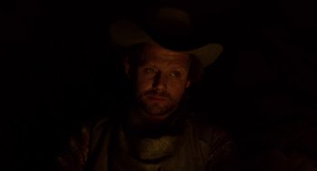 Movie still from “The Ballad of Gregorio Cortez” (1982), directed by Robert M. Young – A man wearing a cowboy hat in the dark; Close Up shot, Low angle
