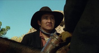 Movie still from “The Ballad of Gregorio Cortez” (1982), directed by Robert M. Young – A man wearing a cowboy hat is holding a gun; Close Up shot, Low angle