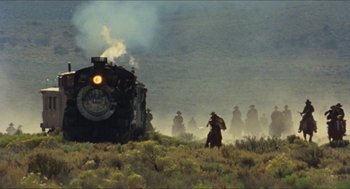 Movie still from “The Ballad of Gregorio Cortez” (1982), directed by Robert M. Young – A group of men riding on the back of a train; Extreme Wide shot, Low angle