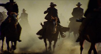 Movie still from “The Ballad of Gregorio Cortez” (1982), directed by Robert M. Young – A group of men riding on the backs of horses; Wide shot, Low angle