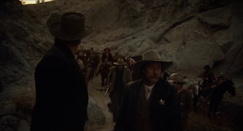Movie still from “The Ballad of Gregorio Cortez” (1982), directed by Robert M. Young – A group of men walking down a dirt road; Wide shot, Low angle
