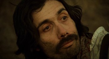 Movie still from “The Ballad of Gregorio Cortez” (1982), directed by Robert M. Young – A person with long hair and a beard; Close Up shot, Low angle