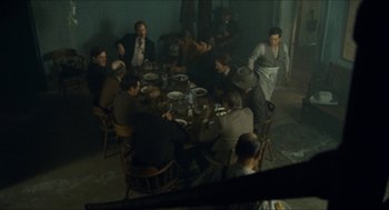 Movie still from “The Ballad of Gregorio Cortez” (1982), directed by Robert M. Young – A group of people sitting around a table eating food; Wide shot, High angle