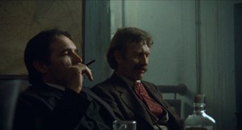 Movie still from “The Ballad of Gregorio Cortez” (1982), directed by Robert M. Young – Two men sitting next to each other in a room; Medium shot, Low angle