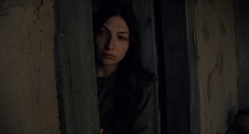 Movie still from “The Ballad of Gregorio Cortez” (1982), directed by Robert M. Young – A woman standing in a dark room looking at the camera; Close Up shot, Low angle