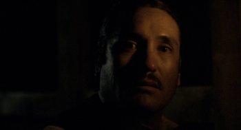 Movie still from “The Ballad of Gregorio Cortez” (1982), directed by Robert M. Young – A person's face in the dark; Close Up shot, Low angle