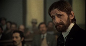 Movie still from “The Ballad of Gregorio Cortez” (1982), directed by Robert M. Young – A person wearing a suit and a tie; Close Up shot, Over the shoulder angle