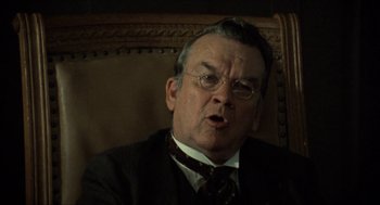 Movie still from “The Ballad of Gregorio Cortez” (1982), directed by Robert M. Young – An older man wearing a suit and tie; Close Up shot, Low angle