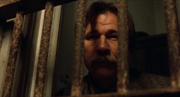 Movie still from “The Ballad of Gregorio Cortez” (1982), directed by Robert M. Young – A person behind a fence; Close Up shot, Low angle