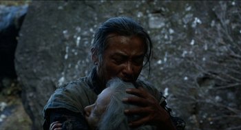 A man holding a baby in his arms