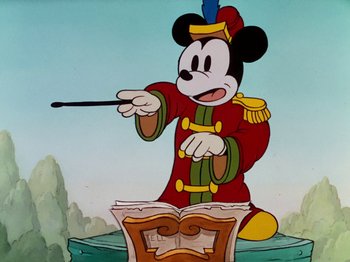 Movie still from “The Band Concert” (1935), directed by Wilfred Jackson – A cartoon of mickey mouse playing a musical instrument; Medium shot, Low angle