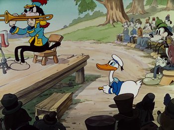 Movie still from “The Band Concert” (1935), directed by Wilfred Jackson – A scene from a cartoon with a duck and a person on a stage; Wide shot, Over the shoulder angle