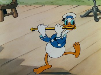 Movie still from “The Band Concert” (1935), directed by Wilfred Jackson – A drawing of donald duck holding a baseball bat; Medium shot, High angle