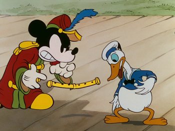 Movie still from “The Band Concert” (1935), directed by Wilfred Jackson – Mickey mouse and donald duck in a scene from the disney cartoon; Medium shot, Over the shoulder angle