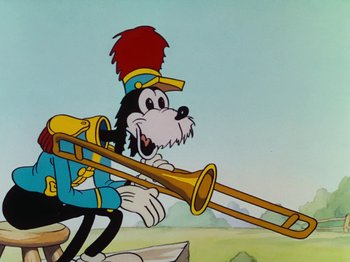 Movie still from “The Band Concert” (1935), directed by Wilfred Jackson – A cartoon of a dog playing a trombone; Medium shot, Low angle
