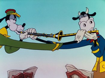 Movie still from “The Band Concert” (1935), directed by Wilfred Jackson – Two goofy cartoon characters are playing a musical instrument together; Wide shot, Low angle