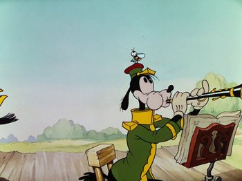 Movie still from “The Band Concert” (1935), directed by Wilfred Jackson – A goofy cartoon character is playing a violin; Medium shot, Low angle