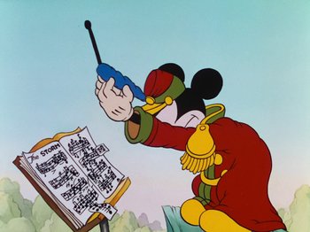 Movie still from “The Band Concert” (1935), directed by Wilfred Jackson – A cartoon of a mickey mouse playing a musical instrument; Medium shot, Low angle