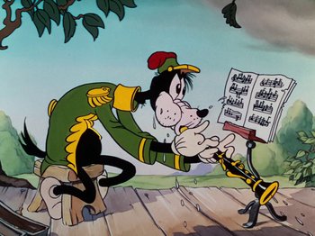 Movie still from “The Band Concert” (1935), directed by Wilfred Jackson – A painting of a dog playing a musical instrument while another dog watches; Medium shot, Low angle