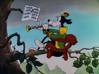 Movie still from “The Band Concert” (1935), directed by Wilfred Jackson – A goofy character playing the clarinet in a tree; Wide shot, Low angle